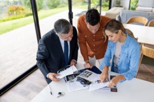 A couple reviews types of investments with their property manager.