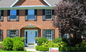 A red brick house with beautiful landscaping