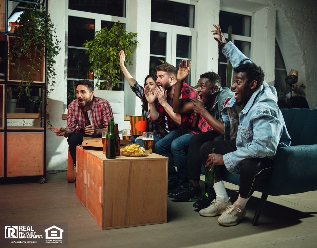 A Diverse Group of Young People Watching the Super Bowl on TV