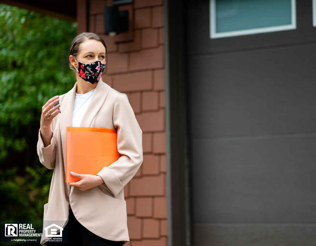 Property Investor Standing in Front of Property with Face Mask