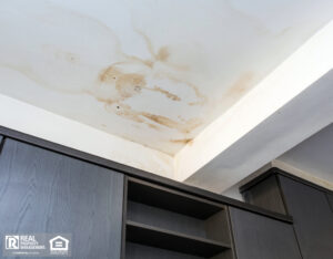 Close up of water damaged ceiling due to roof leakage.