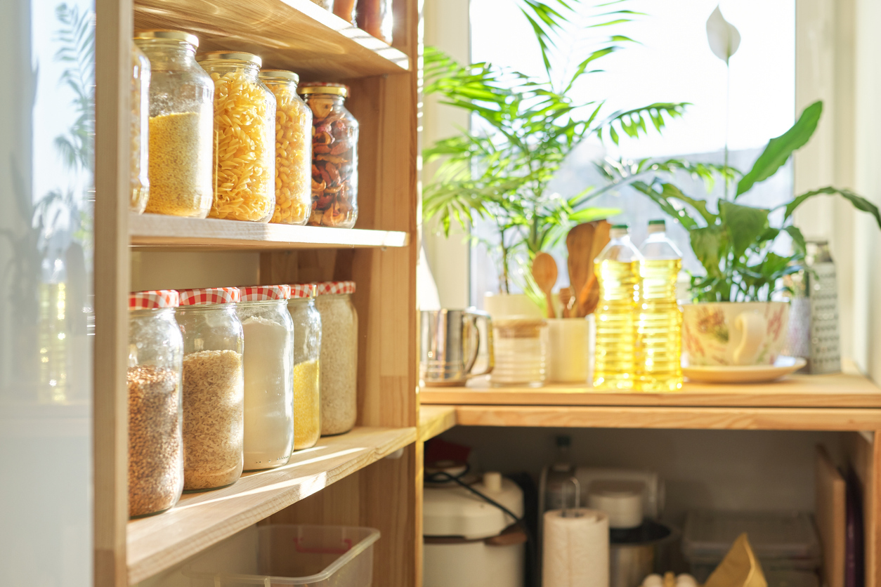 Organized Pantry with Food Items Stored in Glass Containers