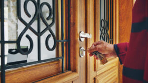 Senior man opening the front door of his vacation rental