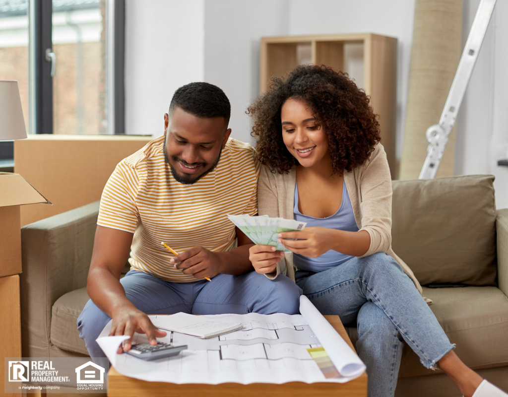 Couple in their new home reviewing budgeting related to property upkeep and maintenance.