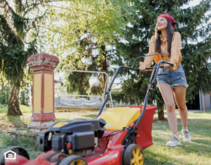 A woman performs summer maintenance by mowing her lawn.