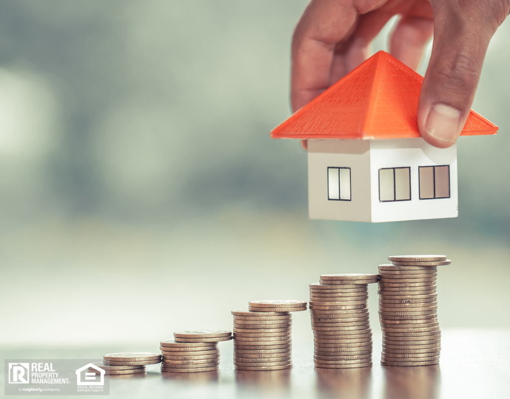 Image of a house over stacks of coins, symbolizing the upward trend in the housing market.