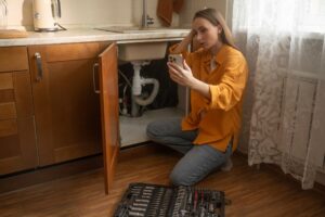 Renter seeks help from property manager as she addresses a malfunctioning sink drain.