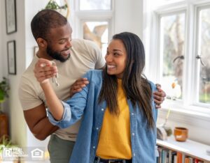 Happy African American couple joyfully holding keys to their new home. 
