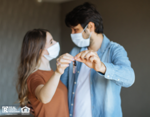 Couple with Face Masks Holding Keys to Their Jericho Apartment