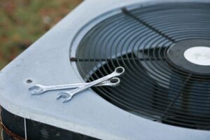Wrenches on top of the outside air conditioner for repair.