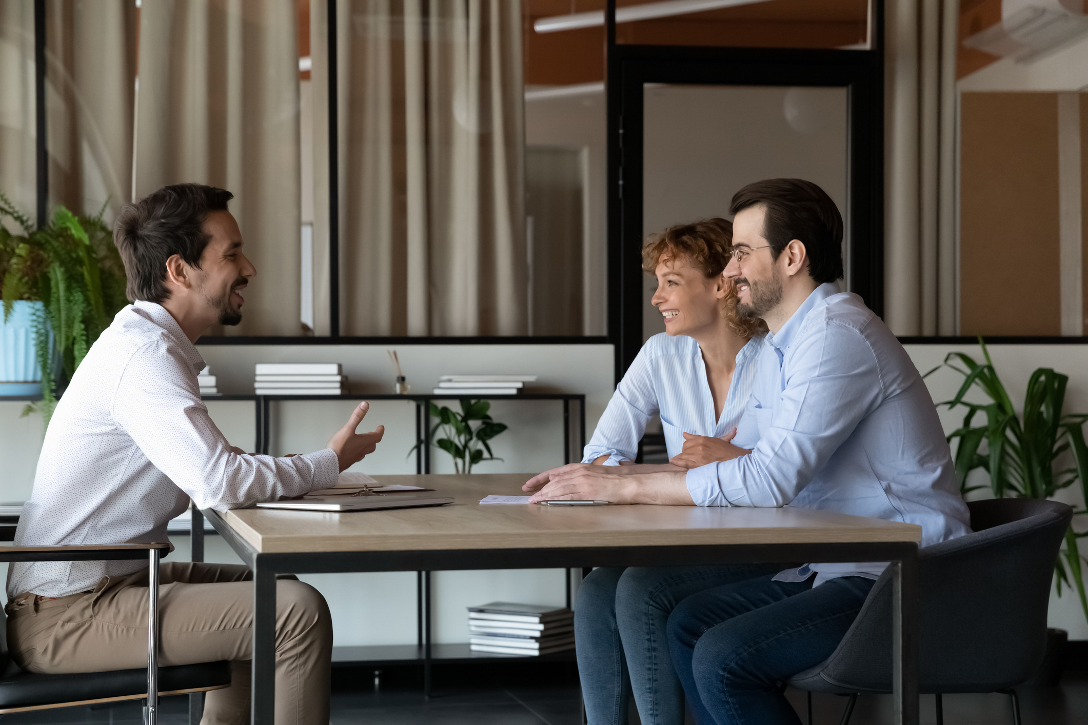 Three people engaged in conversation at a table.