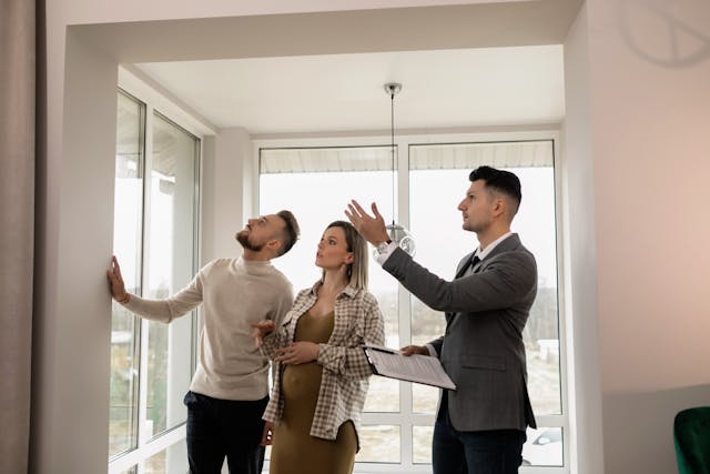 a property manager pointing out details of a house to a couple