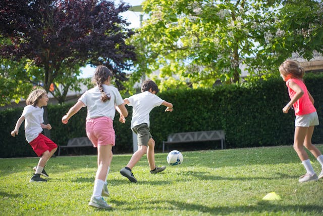 children playing soccer in a park