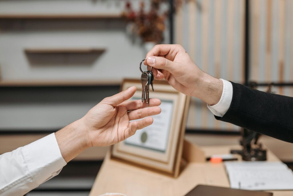 One person handing a set of keys to another person.