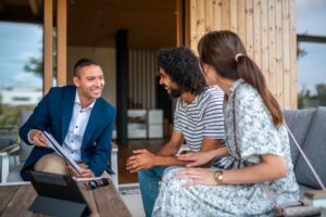 A man and woman discuss their options with a property manager in an office setting.