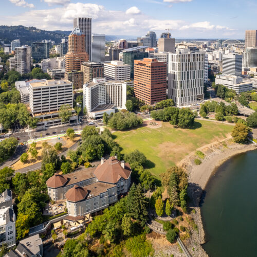 Aerial photos of downtown Portland Oregon on a sunny day with giant buildings and green surfaces