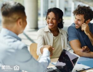 A happy couple shakes hands with their new property manager.