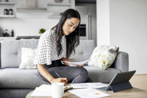 Woman analyzing budget while sitting at home