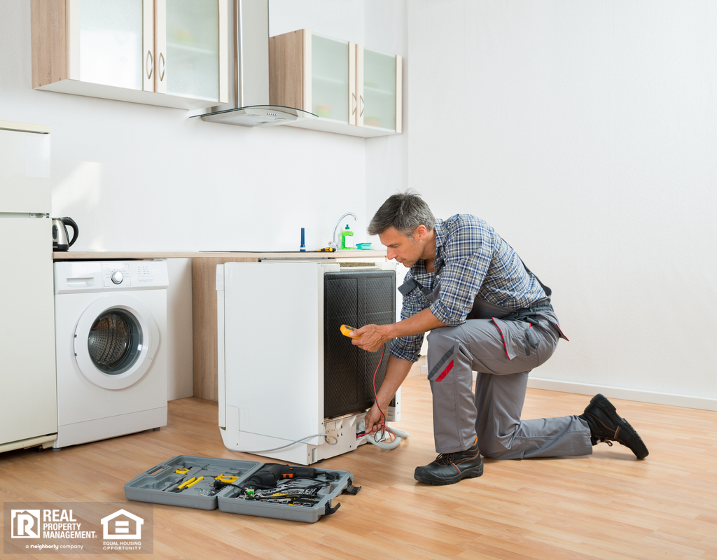 Anacortes Property Manager Doing Maintenance on Appliances