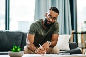 Young man filling out an application to rent a home.
