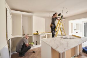 Electricians working in a kitchen remodeling.