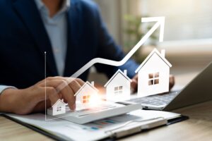 A businessman uses a calculator to determine home price, highlighting real estate investment and portfolio management.