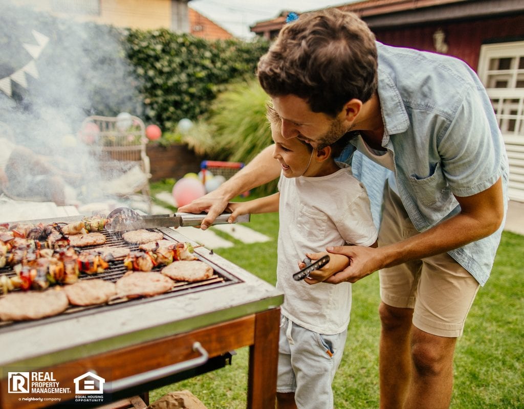 Father and Son Grilling in Yard of Rio Rancho Rental Property