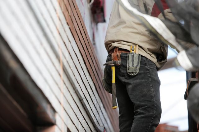 a person on a ladder with a hammer