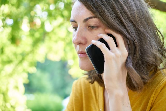 person taking a phone call outdoors