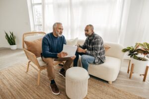 Senior man and adult son meeting to discuss family legacy and generational wealth