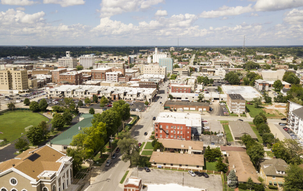 The downtown city skyline and buidlings of Sprigfield MO under partly cloudy skies aerial perspective