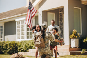 American soldier receiving a warm welcome from her husband and kids.