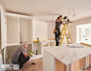 Electricians working in a kitchen remodeling.