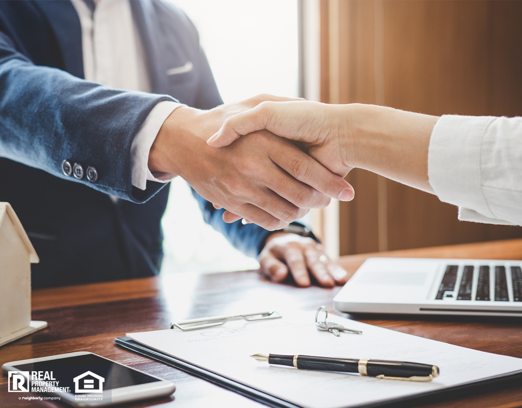 Real estate agent and managers shaking hands together celebrating finished contract.