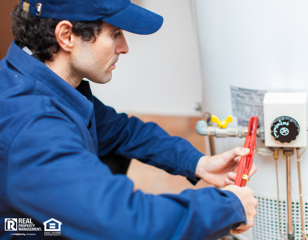 Plumber Working on a Water Heater in a Fort Lauderdale Rental