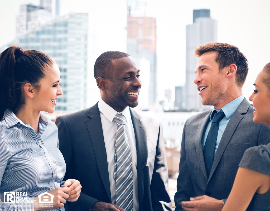 A Group of Peachtree Corners Real Estate Investors Talking in Front of a City Skyline