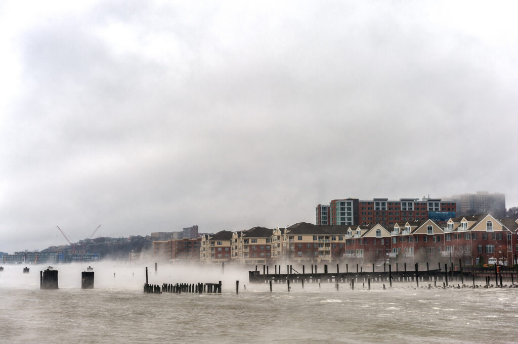 Hudson river in Winter with Misty Edgewater Cityscape in Background
