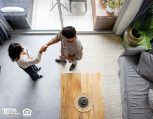High angle view of a landlord greeting a renter with a handshake at a rental home.