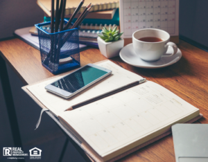 A Desk with a Planner, Phone, Coffee, and Laptop