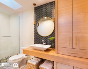 A clean bathroom featuring a sink, toilet, and a shower, all in a modern design.