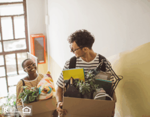 Flatmates moving into a college dorm, carrying boxes.