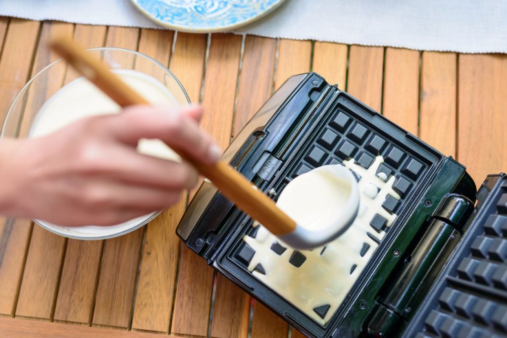 Owasso Tenant Making Waffles in a Waffle Iron