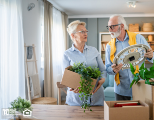 An older couple look overwhelmed as they pack up their home.