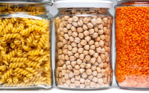 Three Cans of Noodles, Beans, and Lentils on a Shelf