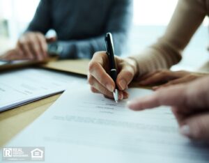 Close up of unrecognizable woman signing a contract in the office.