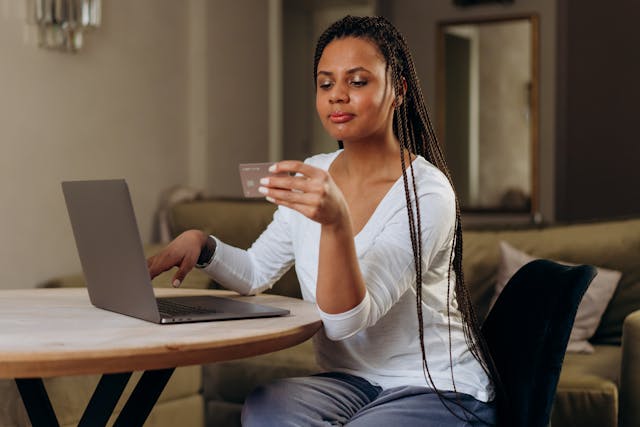 person holding a credit card to make an online payment