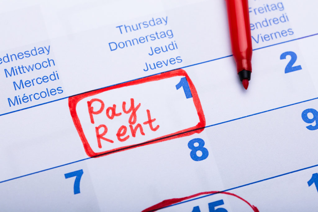A Calendar with a Written Note to Pay Rent on the 1st