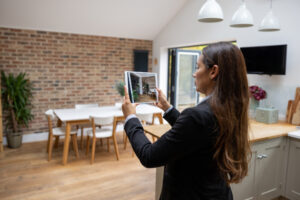 Real estate agent doing a virtual showing of a property using a tablet.