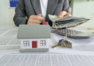 Home buying process with cash and calculations at a real estate office in a professional setting