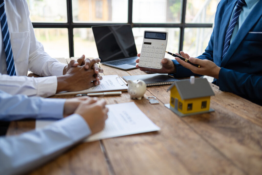 Businessman is offering a house price to a customer. Businessman, real estate agents discuss house sale prices, fee, mortgage, interest, rent, cash flow, loan.